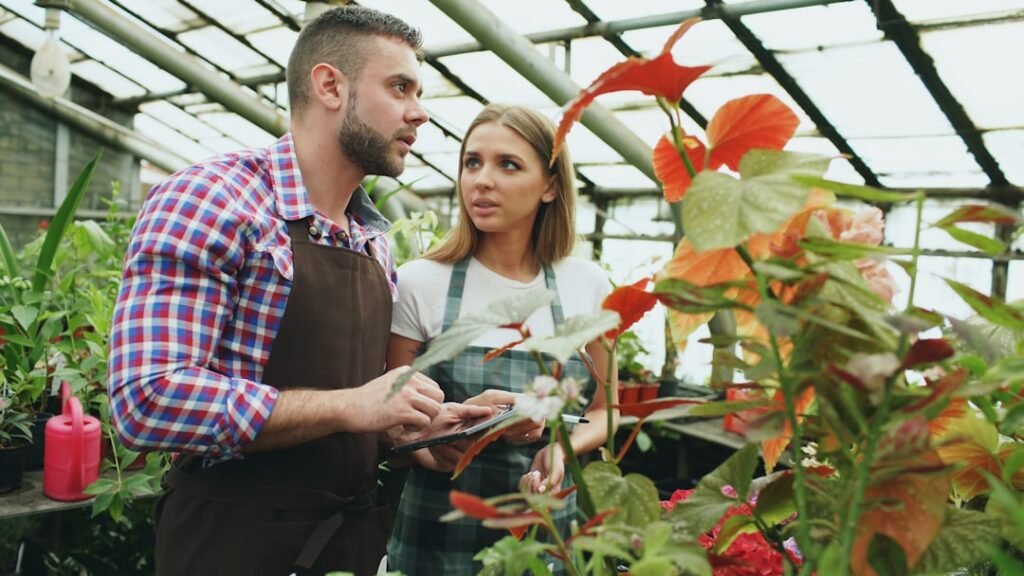 Growers learning and working with plants in a greenhouse